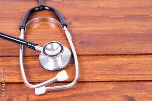 A stethoscope on wooden background