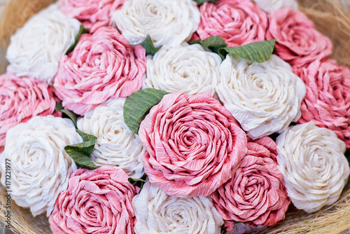 A bouquet of artificial white and pink roses