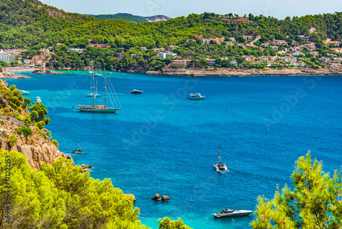 Island scenery at the bay of Camp de Mar with boats at the beautiful coast on Majorca island, Spain