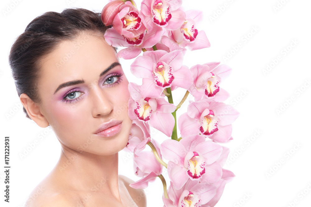 Young beautiful healthy girl with clean pink make-up and orchid, copy space