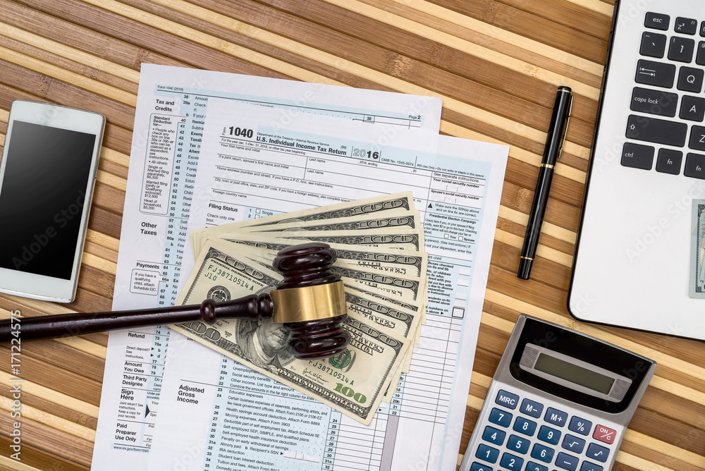 Obraz premium hammmer, tax form, dollar and laptop - business concept