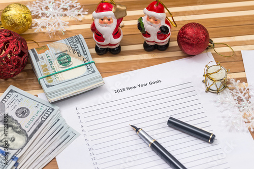 new year goals 2018 with calendar, cristmas touy and dollar cash photo