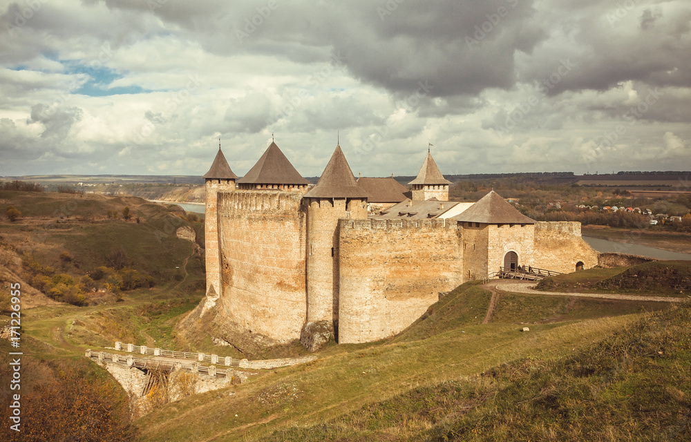 Clouds over the old town and Khotyn fortress, Ukraine. The castle is located on the right bank of the Dniester River. Built in the 14th century Clouds over the old town and Khotyn fortress, Ukraine. The castle is located on the right bank of the Dniester River. Built in the 14th century