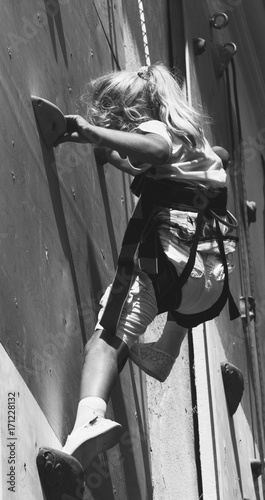 The little Girl in the simulator Climbing Wall, black and white photo