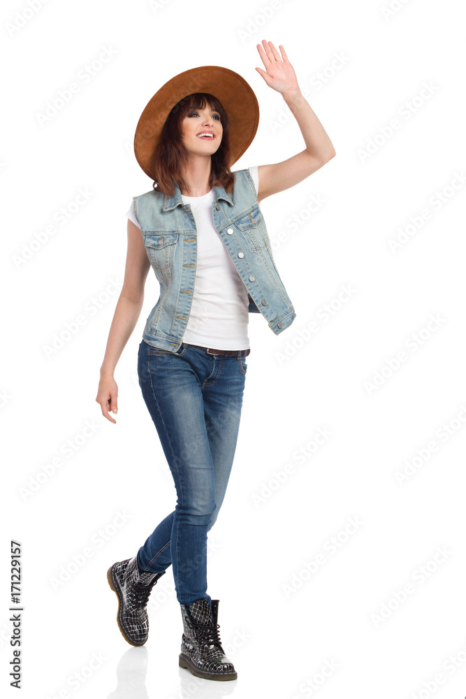 Happy Young Woman Is Walking, Waving Hand And Looking Away Happy Young Woman Is Walking, Waving Hand And Looking Away