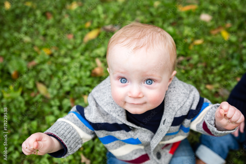 Portrait of smiling baby boy sitting on grass Portrait of smiling baby boy sitting on grass
