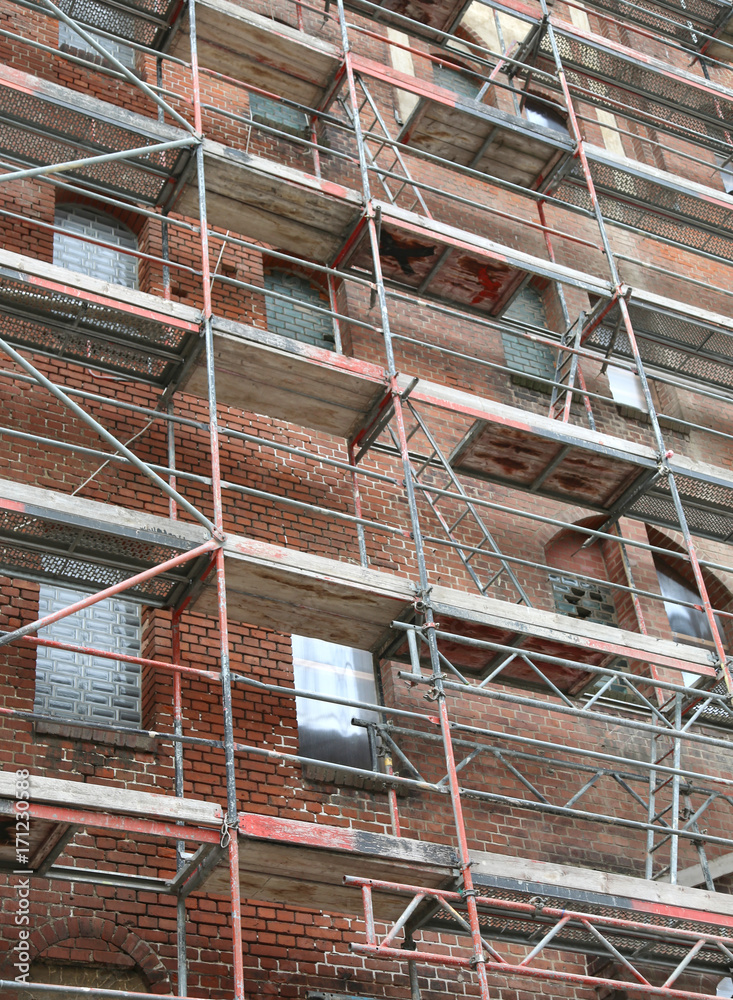 building during maintenance works with the metal scaffold