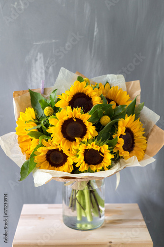 Fototapeta Naklejka Na Ścianę i Meble -  Bouquet of sunflowers and wild flowers on wooden table, copy space