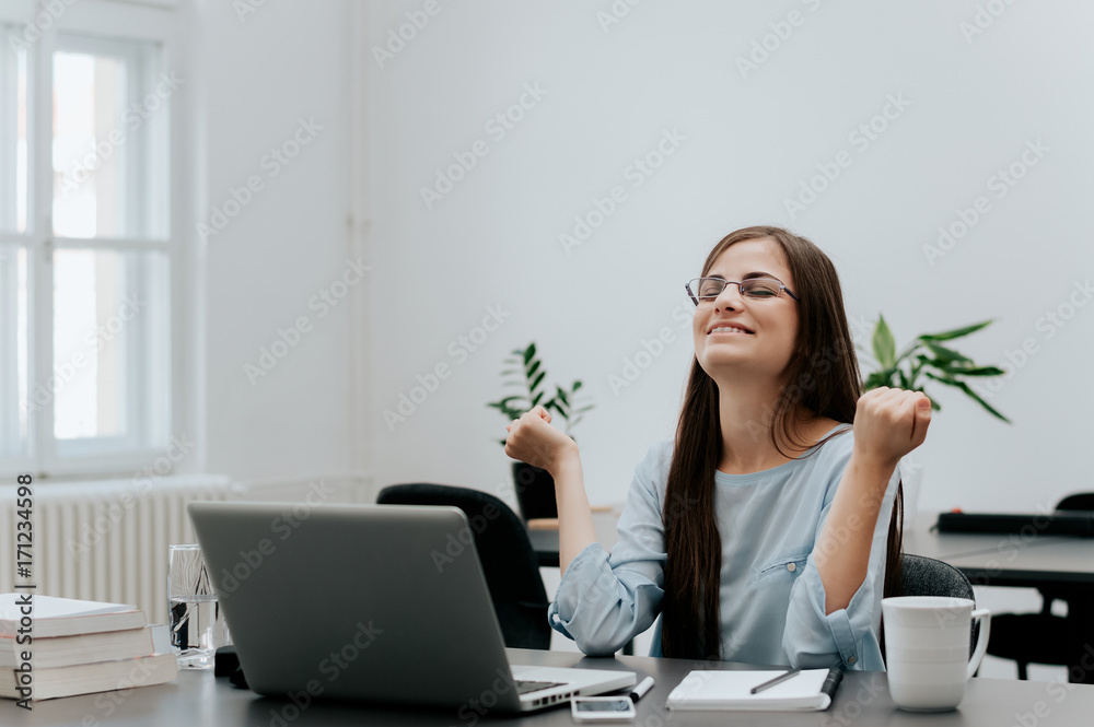 Beautiful woman at the office celebrating her success Beautiful woman at the office celebrating her success
