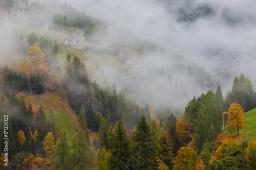 Colorful autumn landscape in the mountain village, morning in Dolimites © gornostaj