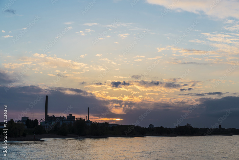 Factories along the Rhine river at sunset in Germany