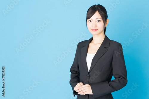 portrait of asian businesswoman isolated on blue background © taka