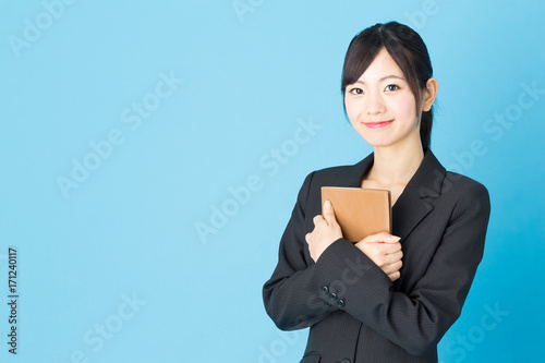 portrait of asian businesswoman isolated on blue background