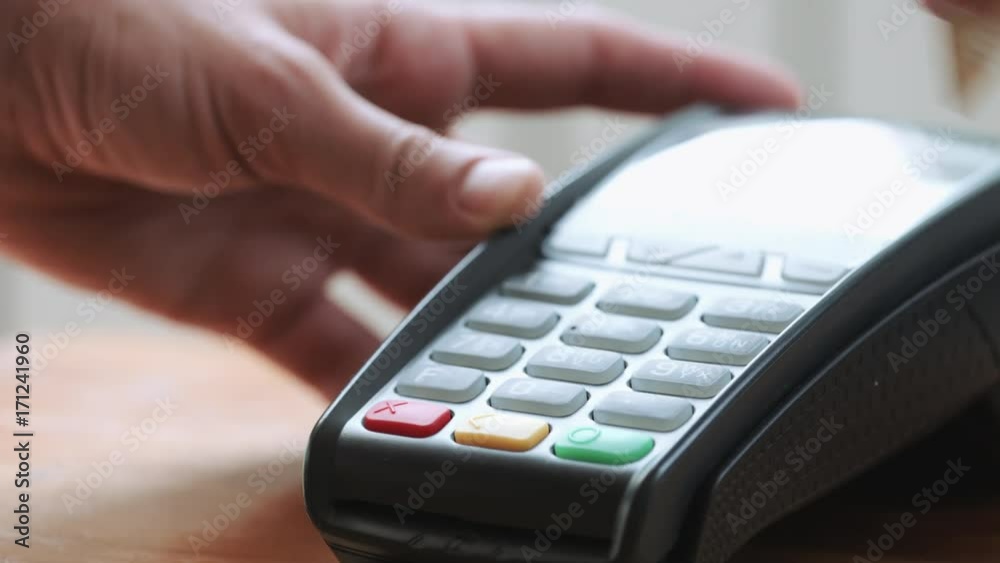 Close-up shot of person using credit card for mobile payment Close-up shot of person using credit card for mobile payment