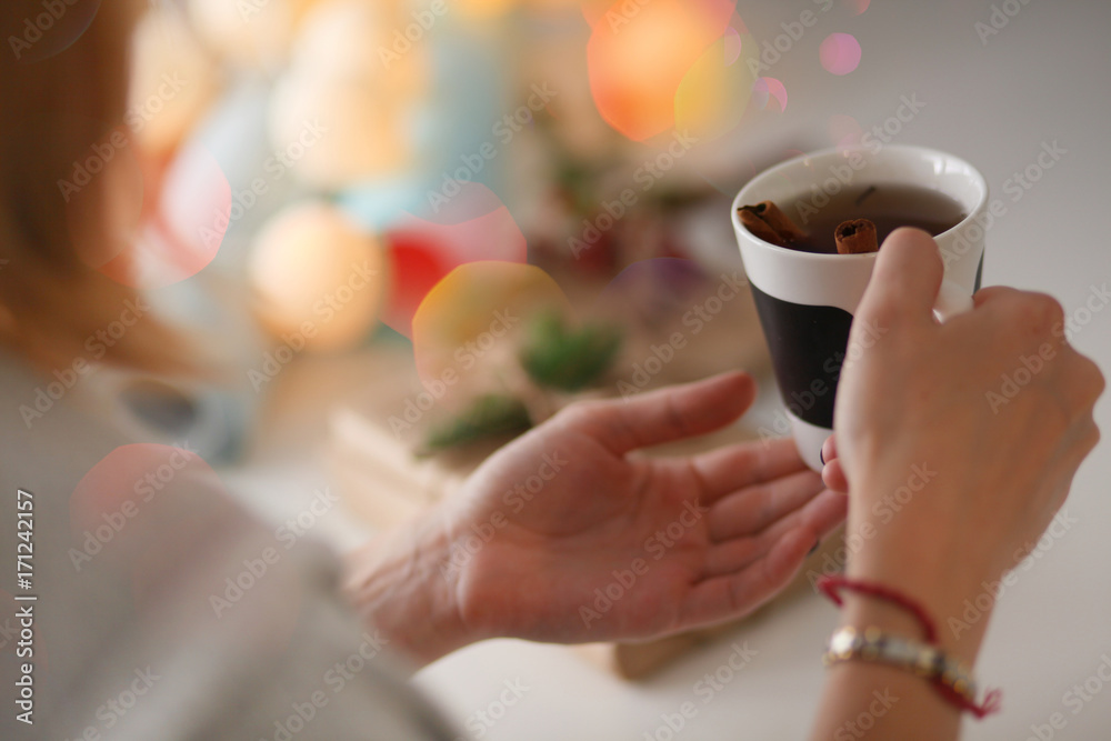Woman sitting on the desk with christmas gift box