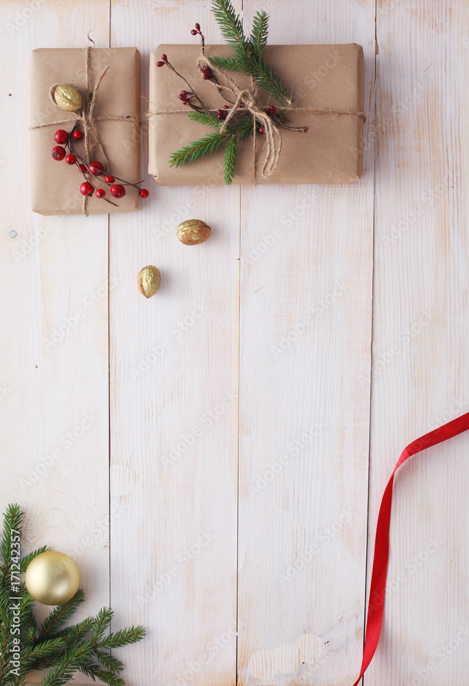 Christmas gift boxes and fir tree branch on wooden table, flat lay Christmas gift boxes and fir tree branch on wooden table, flat lay