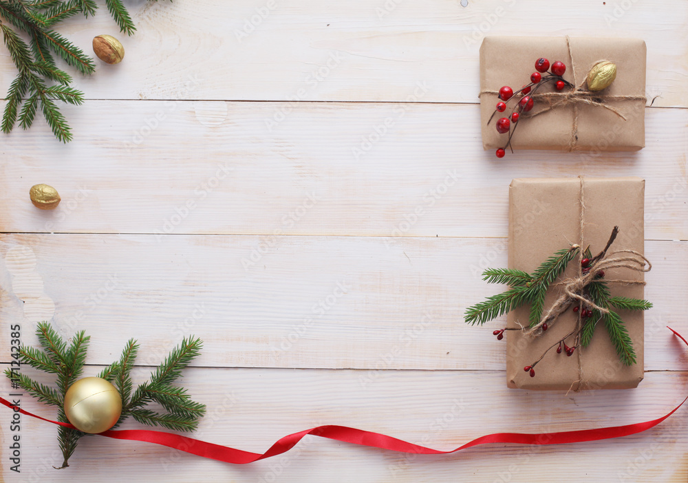Christmas gift boxes and fir tree branch on wooden table, flat lay Christmas gift boxes and fir tree branch on wooden table, flat lay