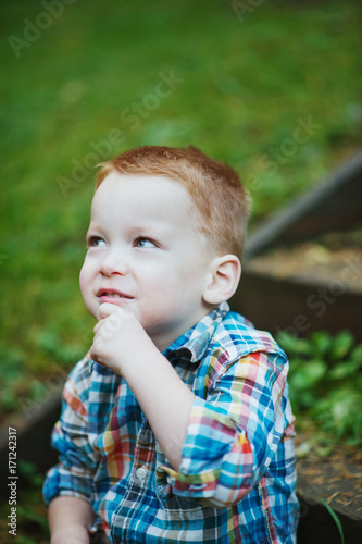 Redhead Boy Sitting and Thinking