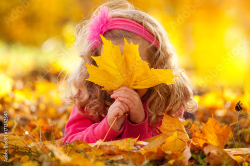 Happy girl in autumn park