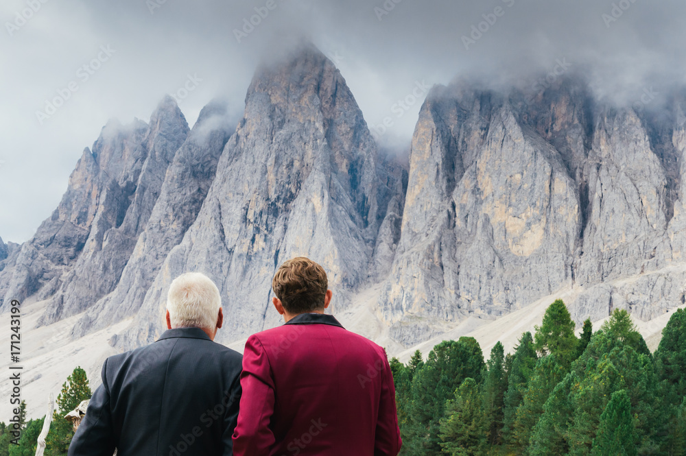 Fototapeta premium Young man and older man admiring view of Dolomite mountains in South Tyrol / Alto Adige, Italy