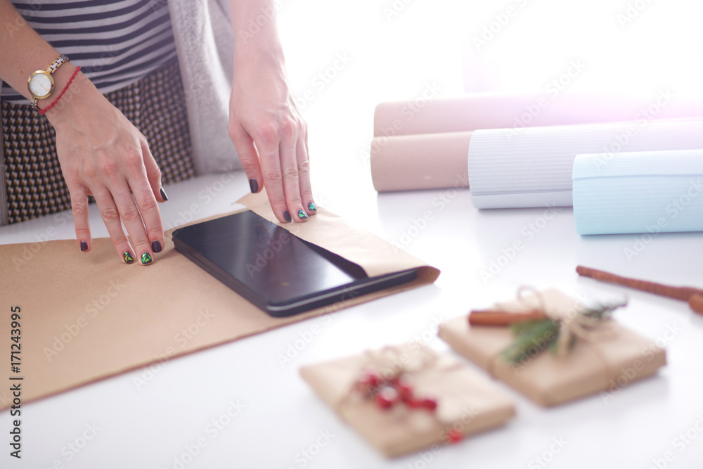 Hands of woman decorating christmas gift box