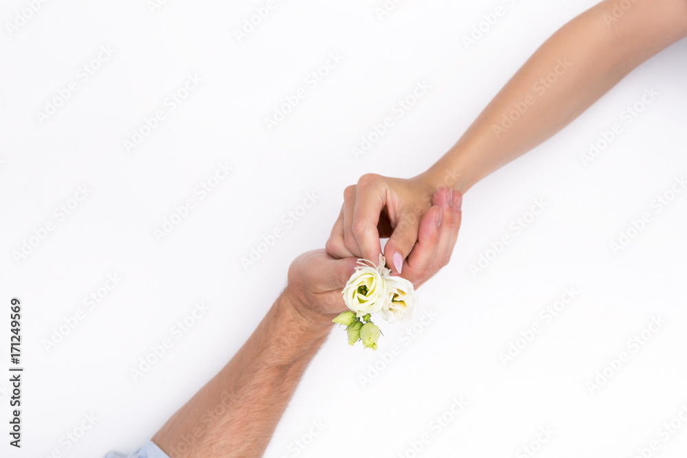 Romantic holding hands with a small bouquet