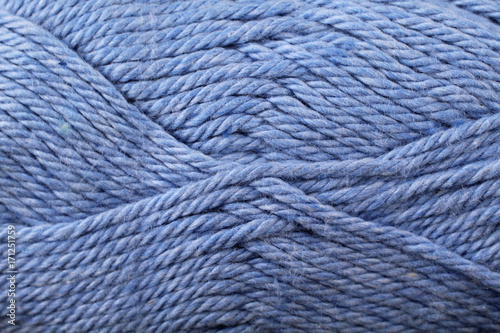 A super close up image of blue yarn