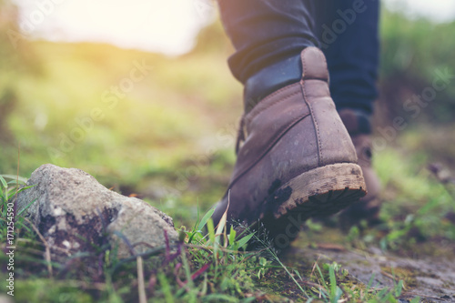 Shoes Man walking on a forest path in autumn and Lifestyle hiking concept.
