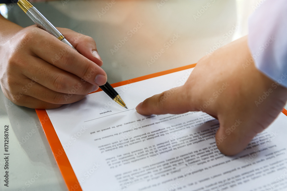 Close up of business man signing contract making a deal, business contract details. Businessman signing an official document Close up of business man signing contract making a deal, business contract details. Businessman signing an official document