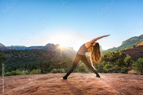 Woman Doing Yoga to Early Morning Sunrise