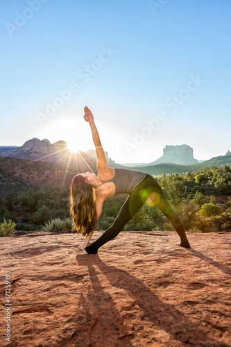 Woman Doing Yoga to Early Morning Sunrise