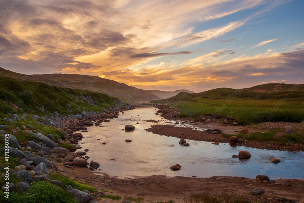 Sunset over the river in the tundra