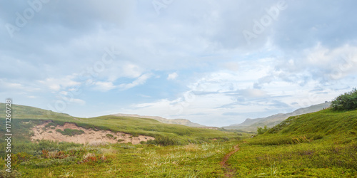 Fototapeta Naklejka Na Ścianę i Meble -  A trail along the green valley of the tundra in the north of Russia