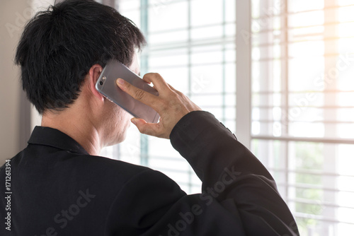 Business man making a phone call with smartphone.