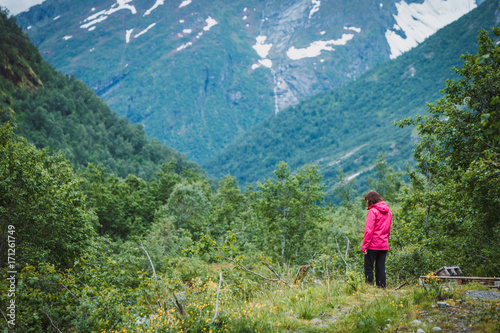 Tourist woman enjoying mountains landscape in Norway.