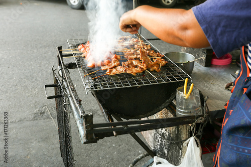 Local seller make roasted meat at Talad Phu market, Bangkok, Thailand
