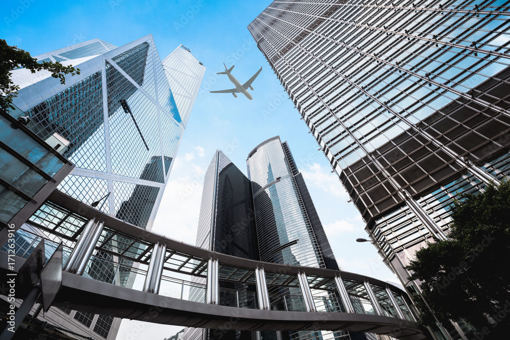 Modern buildings in central Hong Kong with airplane in the sky