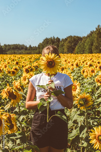 Beautiful stylish hippie girl on the sunflower field