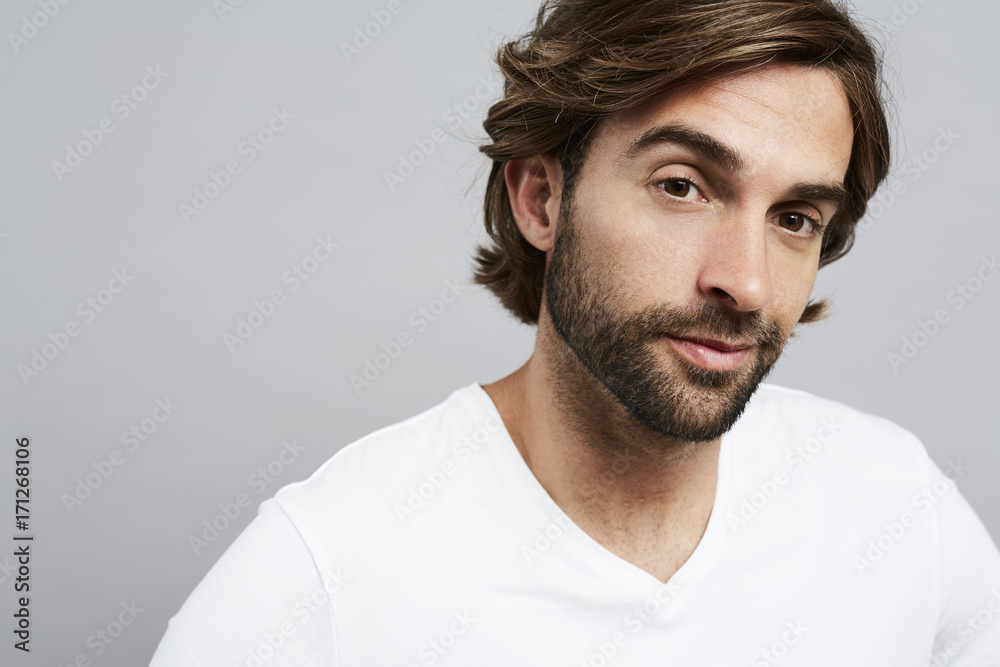 Handsome dude in white looking at camera Handsome dude in white looking at camera