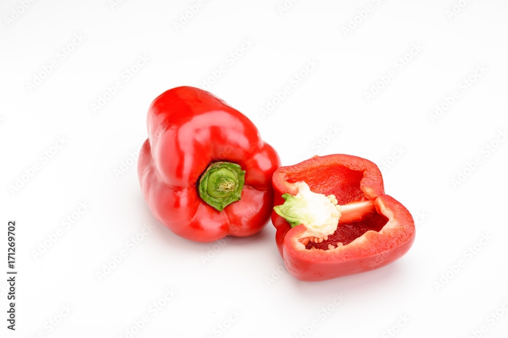 Closeup of a whole and halved red capsicum isolated on white background. Closeup of a whole and halved red capsicum isolated on white background.