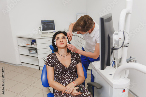 Setting and determining bite and position of jaws with the help of a device with a neuromuscular stimulator. Myo-monitor in the dentist's office. Transcutaneous electrical nerve stimulation. photo