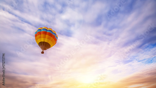 Colorful hot air balloon flying over the sky as background at sunrise