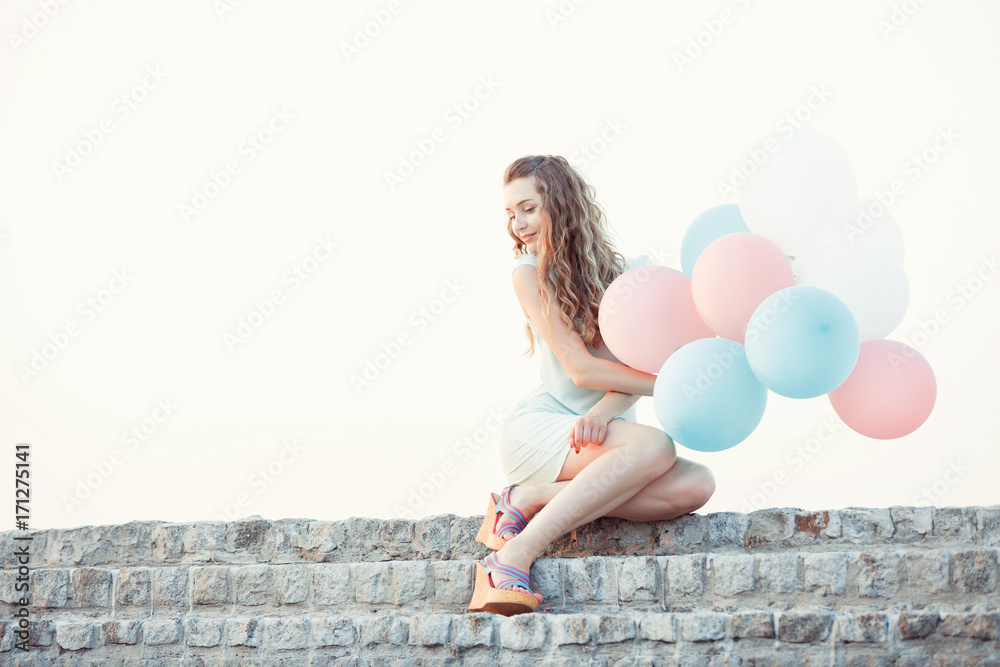 beautiful woman with flying multicolored balloons beautiful woman with flying multicolored balloons