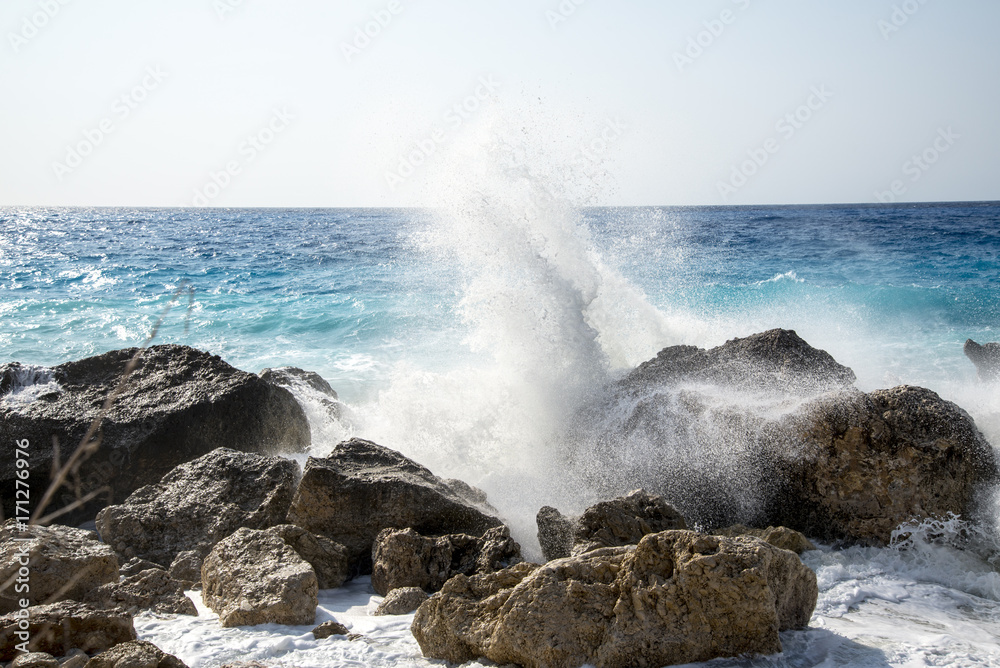 Enormous waves crashing on the shore and on the rocks at the Kavalikefta Beach at the sunset, Lefkada Island, Greece
