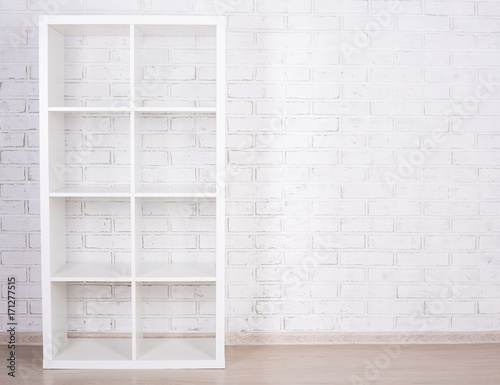 white wooden shelf over white wall
