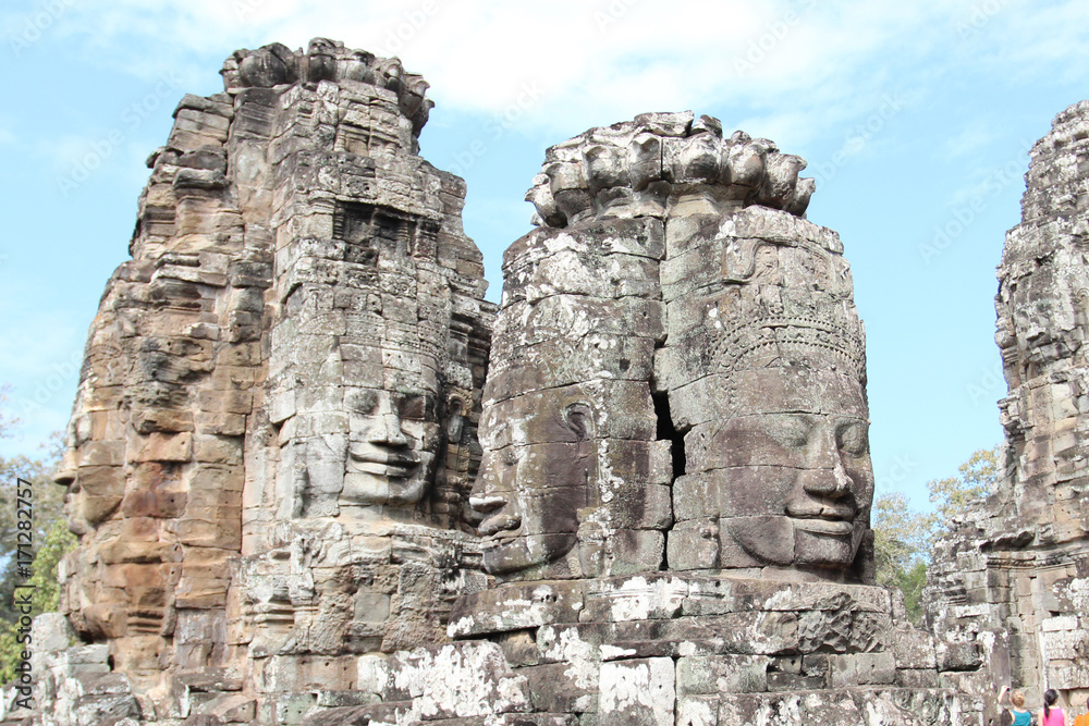 The ruins of an old temple with stone heads and faces in Cambodia