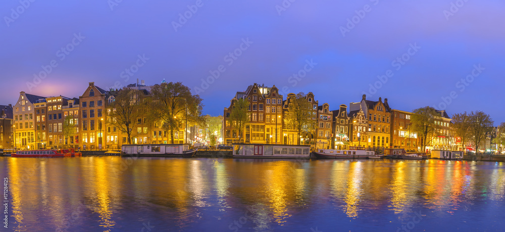 Amsterdam sunset panorama city skyline at canal waterfront, Amsterdam, Netherlands