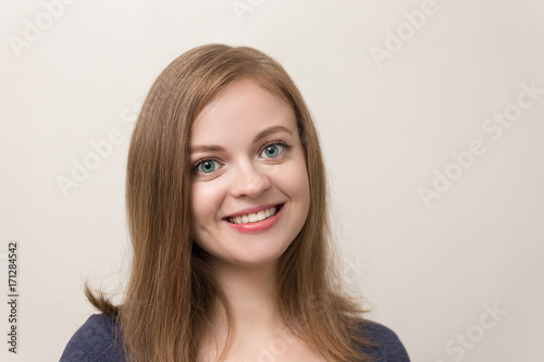 Portrait of cute caucasian girl smiling, close up