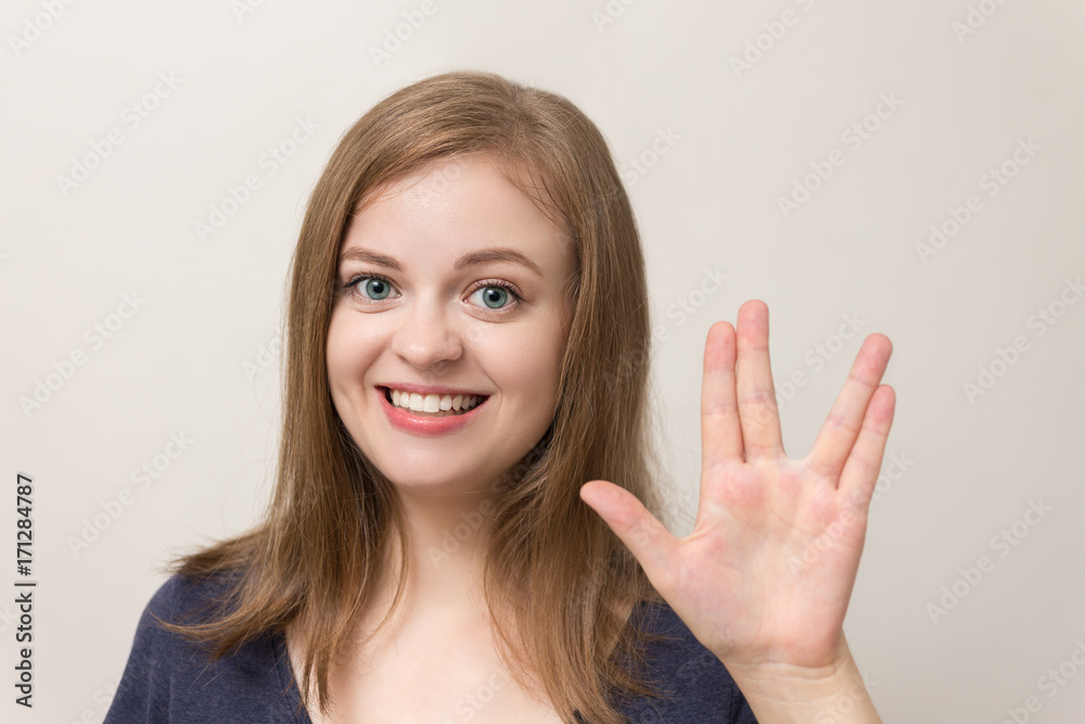 Young caucasian woman shows vulcan greeting Young caucasian woman shows vulcan greeting
