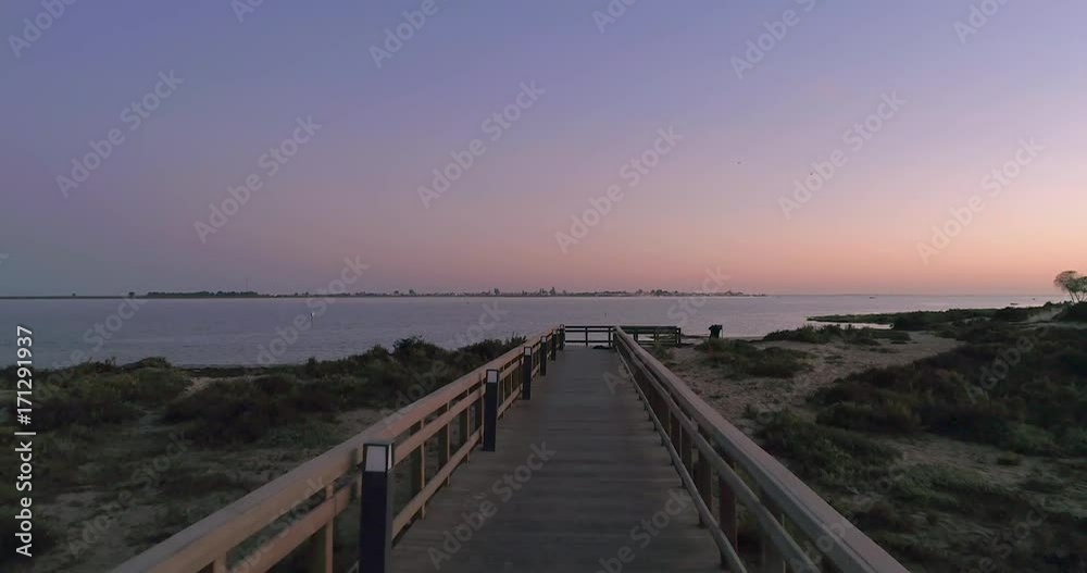 Dusk aerial seascape, in Ria Formosa wetlands natural park, shot at 60m altitude over Cavacos beach. Algarve. Dusk aerial seascape, in Ria Formosa wetlands natural park, shot at 60m altitude over Cavacos beach. Algarve.